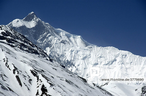 Ice-covered mountain range Grand Barriere with peak Khangsar Kang Annapurna Region Nepal