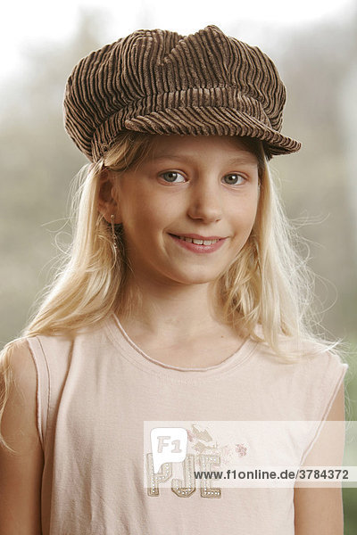 Young smiling girl with cap