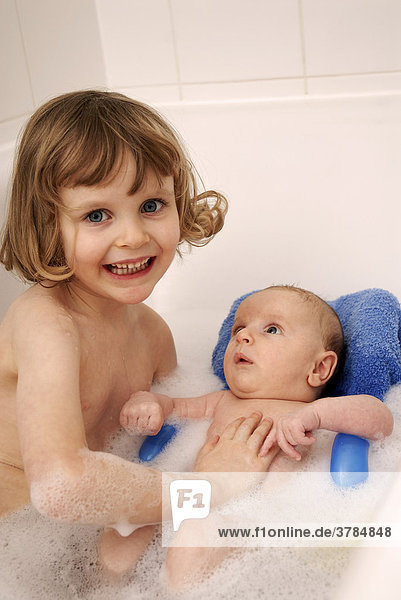 Little girl and her brother sitting in a bath tub (4 years and 2 month old)