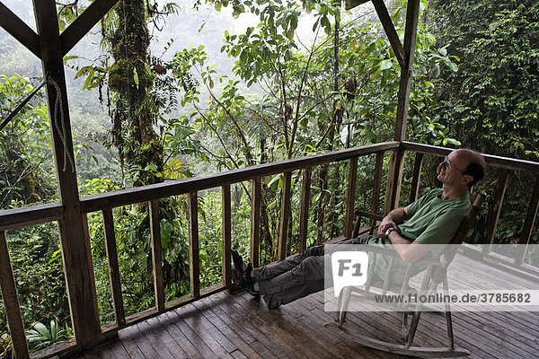 Man in rocking chair  Rara Avis Lodge  River Edge Cabin  Las Horquetas  Costa Rica