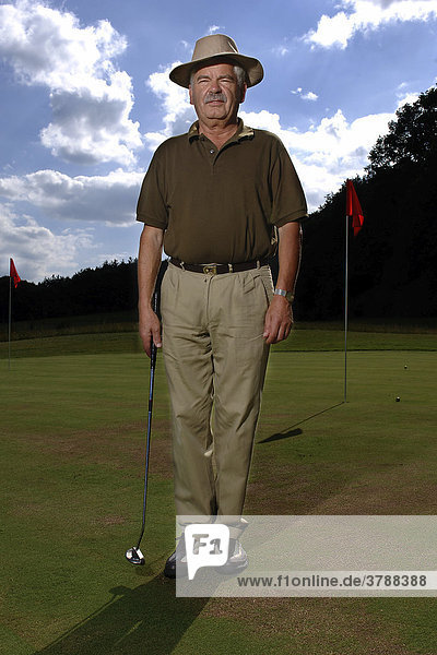 64 year old man playing golf