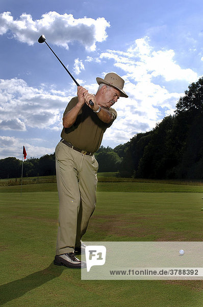 64 year old man playing golf