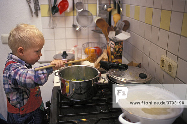 Little one year old boy cooking