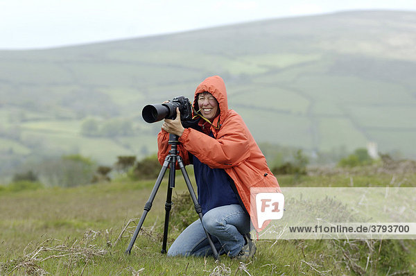 Photographer with tripd near Ashburton Dartmoor National Park Devon England