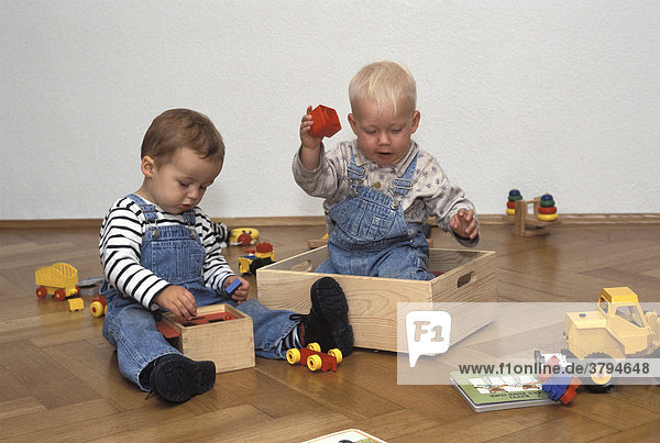 One and one-and-a-half-year-old boys playing