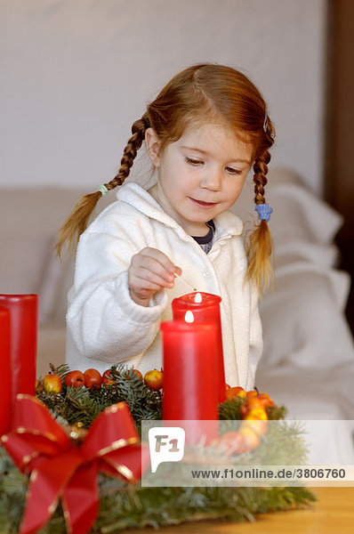 Child with advent wreath with candles