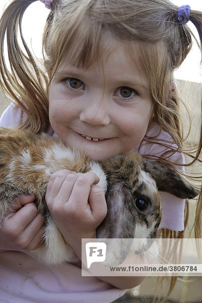 Child with her pet rabbit