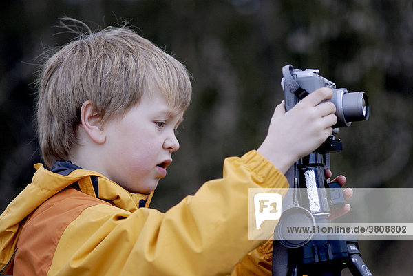 Boy taking photos with a digital camera