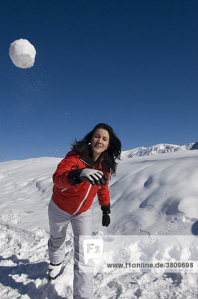 A young woman in a snowball fight
