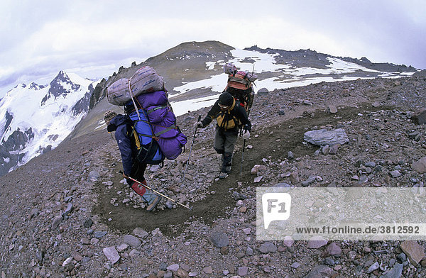 Two climbers carrying heavy backpacks on the normal route of Aconcagua Mendoza Argentina
