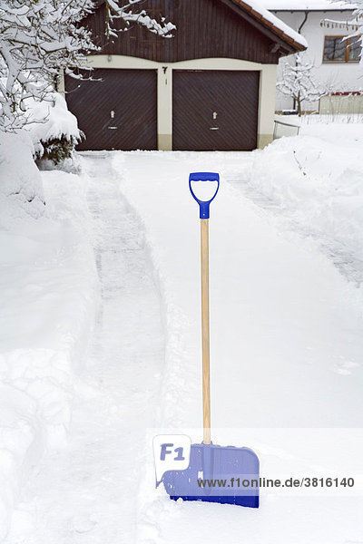 A snow shovel in front of a gateway