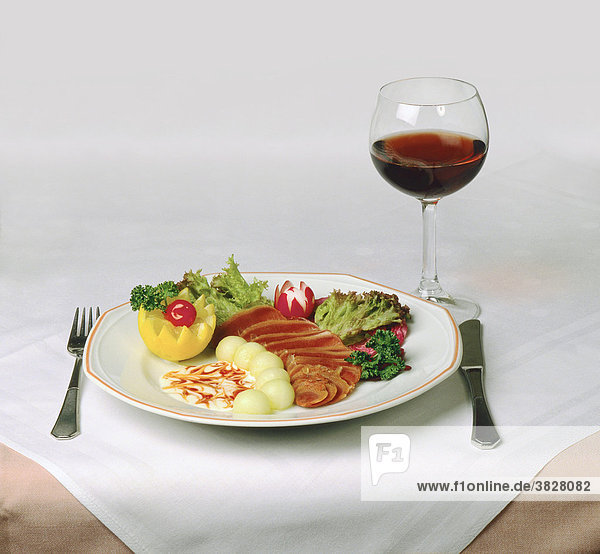 Plate with food and glass of wine