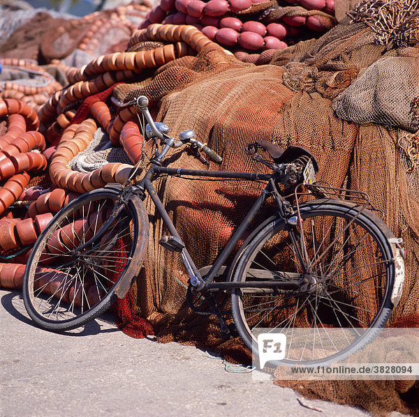 Bicycle leaning on fishing nets  Peniche  Portugal