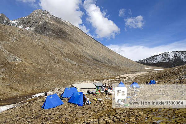 Camp of blue tents in high mountains below Shug-La Pass Tibet China