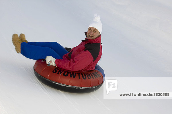 Snowtubing funny slide in winter near Bayerischzell Upper Bavaria Germany