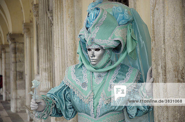 Turquoise mask under arcades  carneval in Venice  Italy