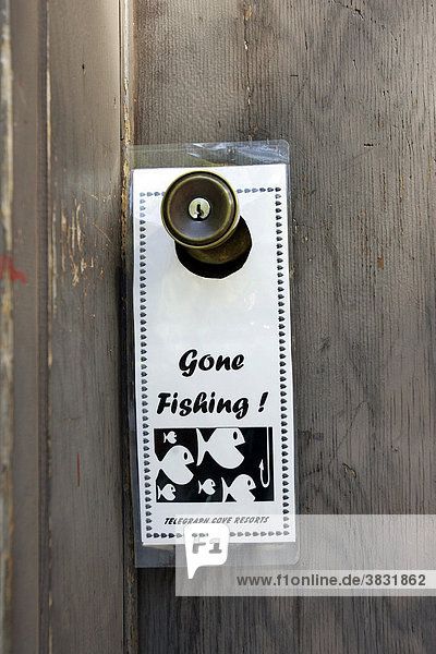 Gone Fishing sign on a doorknob