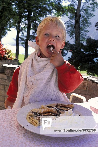Two-year-old eating cream - Aachensee - Tirol - Austria MR