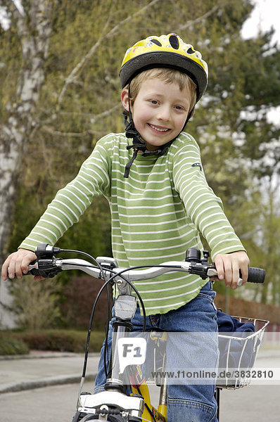 Boy on bicycle with bicycle helmet