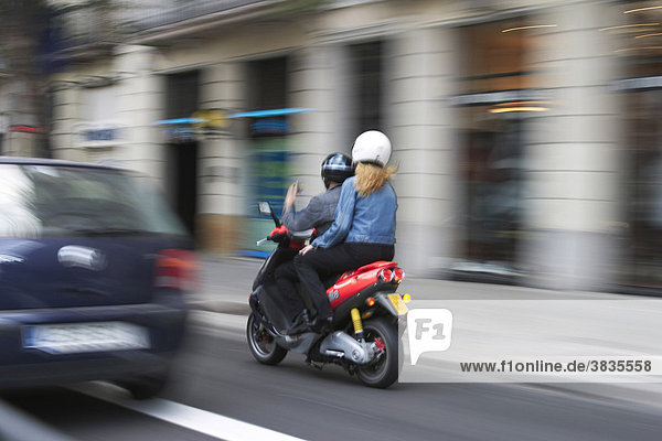Blured picture of an couple driving a scooter in the city of Barcelona (Spain).