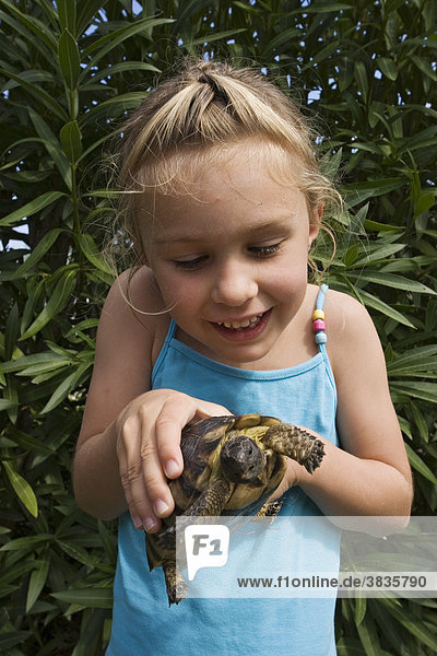 Child with tortoise  Sardinia  Italy