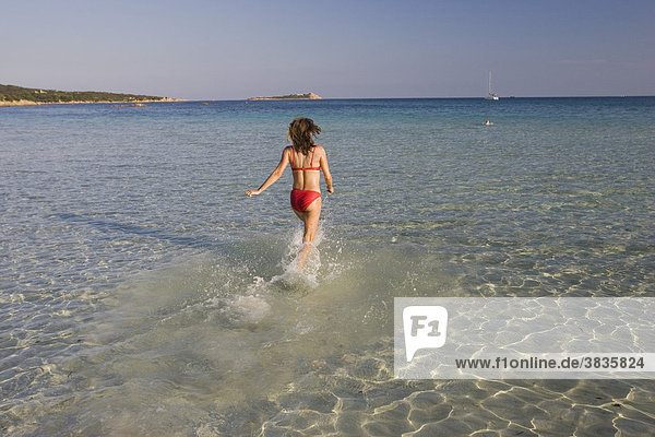 Woman running into the sea  Cala Brandinchi  Sardinia Italy