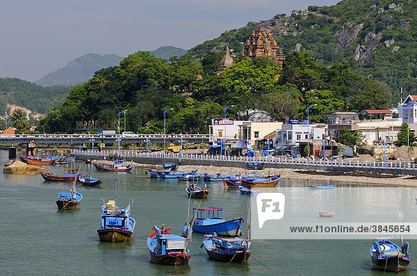 Fishing boats  Port of Nha Trang on the Cai river  in the back the Po Nagar temple  Vietnam  Southeast Asia