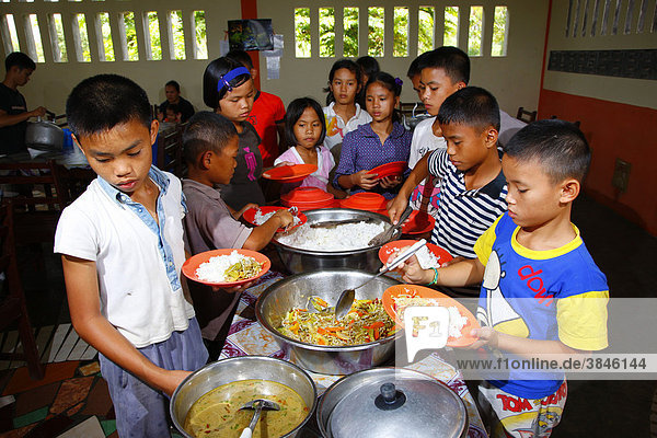 Children dishing out food  Margaritha children's home  Marihat  Batak region  Sumatra island  Indonesia  Asia
