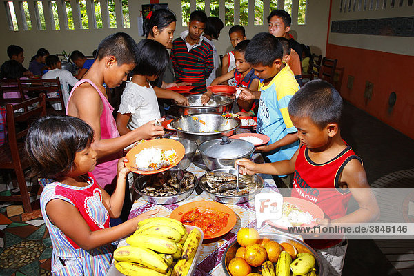 Children dishing out food  Margaritha children's home  Marihat  Batak region  Sumatra island  Indonesia  Asia