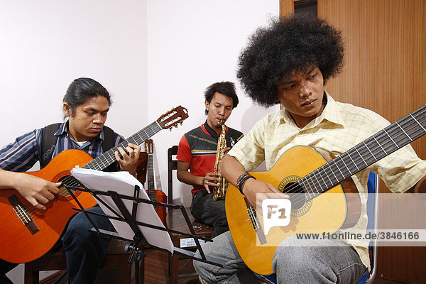 Students learning to play guitar  HKBP Nommensen University  Medan  Sumatra island  Indonesia  Asia