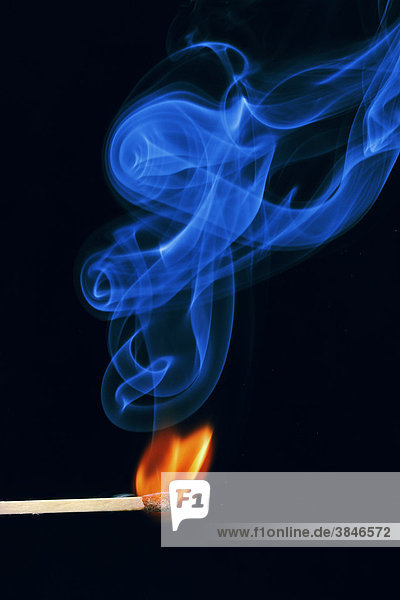 Lit match  flame and blue smoke