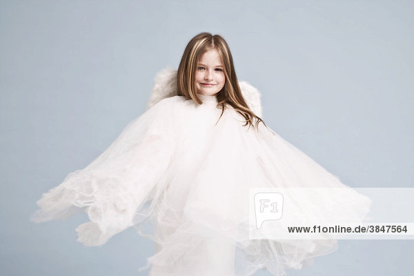 Girl  8 years  in a white dress with angel wings