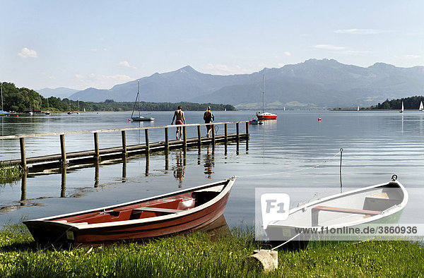 2 small wooden dinghies on the foreshore of lake Chiemsee  Chiemgau  Upper Bavaria  Germany  Europe