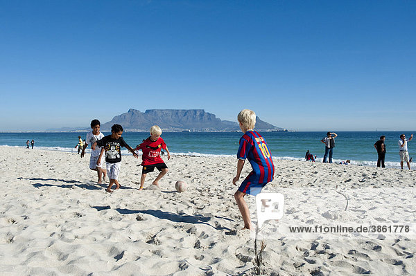 Children playing football on the beach in Bloubergstrand  Table Mountain at back  Cape Town  Western Cape  South Africa  Africa