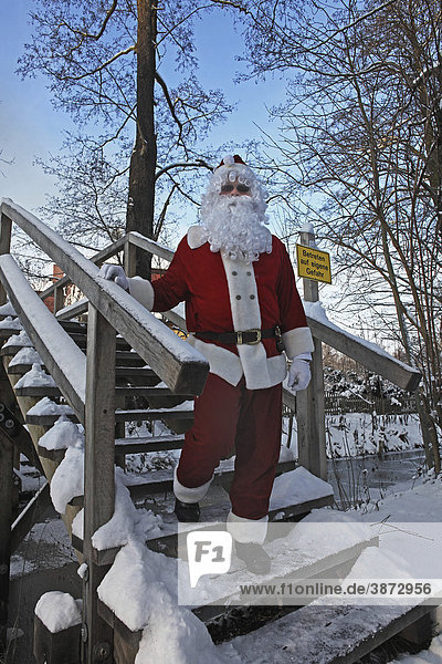 advent  Advent  as  being  beings  bodies  body  Brandenburg  bridge  bridges  brook  brooks  camera  capped  Christmas  Christmas-time  Christmas-y  Christmassy  Christmastime  Christmasy  claus  Claus  Clauses  costume  costumed  costumes  covered  creek  creeks  day  daylight  daytime  direct  directly  disguise  disguised  disguises  dressed  during  East  Eastern  Europe  European  exterior  exteriors  Father  Federal  FRG  frost  German  Germany  hat  hats  human  humans  ice  ice-covered  iced  in  into  Kringle  Kringles  Kris  look  looking  looks  male  man  mas  masquerade  masquerades  masquerading  men  Nicholas  Nick  Nikolaus  of  on  one  outdoor  people  person  persons  photo  photos  region  Republic  Saint  Santa  Santas  season  separate  separately  shot  shots  single  singly  snow  snowy  Spreewald  St  staircase  staircases  stairs  stairway  stairways  stand  standing  stands  step  steps  straight  stream  streams  the  timber  time  up  water  waters  wear  wearing  winter  wintertime  wintery  wintry  wood  wooden  X-mas  Xmas  yule  yuletide