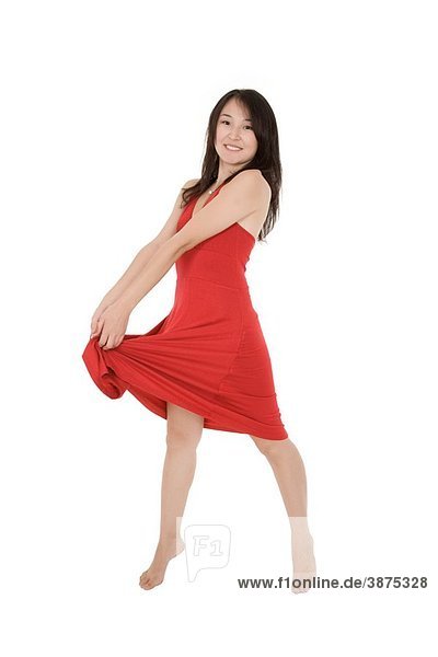 Beautiful Asain woman in a red sundress posing on a white background