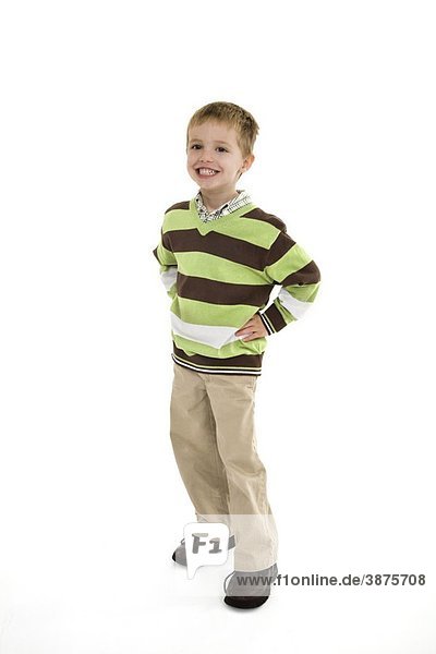 Young caucasian boy dressed in a casual outfit and standing on a white background