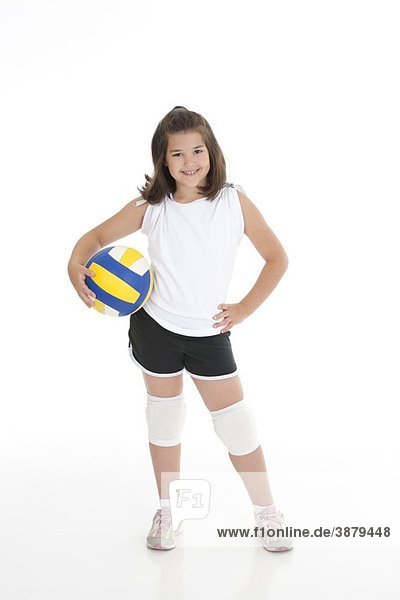 Portrait of a cute eight year old girl in volleyball outfit