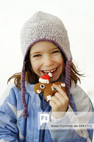 Child with gingerbread  shaped like moose
