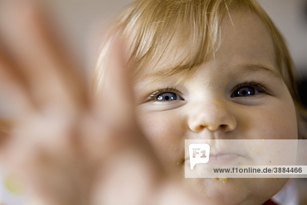 Infant reaching toward camera  portrait