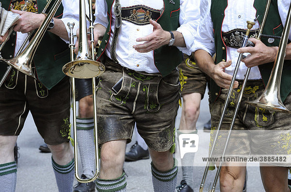Detail of three musicians in traditional lederhosen  short leather pants  Upper Bavaria  Bavaria  Germany  Europe
