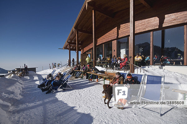Winter visitors on the sun terrace of the Sonnenalm mountain lodge  Chiemgau  Upper Bavaria  Bavaria  Germany  Europe
