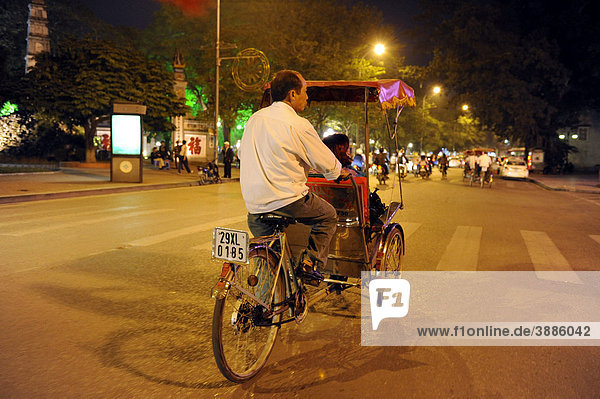 Street scene with bicycle rickshaws at night  Hanoi  North Vietnam  Vietnam  Southeast Asia  Asia