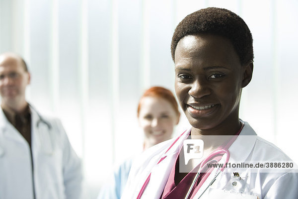 Female doctor  colleagues in background  portrait