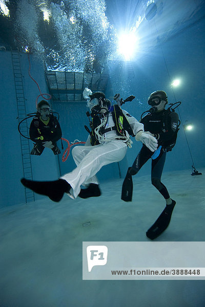 Backup divers and astronauts practicing with a space station module reproduction in a diving basin European Space Agency ESA European Astronaut Center EAC Cologne North Rhine-Westphalia Germany Europe