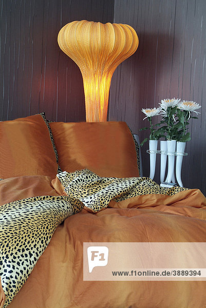 Luxurious bed in an exclusive design with a stylish lamp