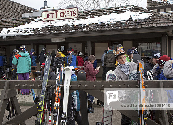 Downhills skiers and snowboarders buy lift tickets at Boyne Mountain ski resort  Boyne Falls  Michigan  USA