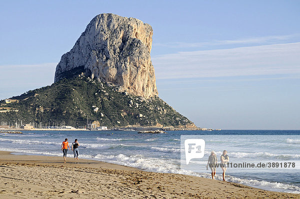 Walkers  tourists  beach  sea  Penon de Ifach rock formation  mountain  Calpe  Costa Blanca  Alicante province  Spain  Europe