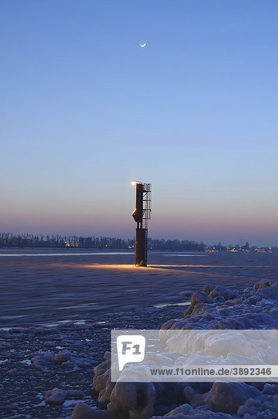 Beleuchtetes Seezeichen auf der winterlichen Elbe bei Hamburg  Deutschland  Europa