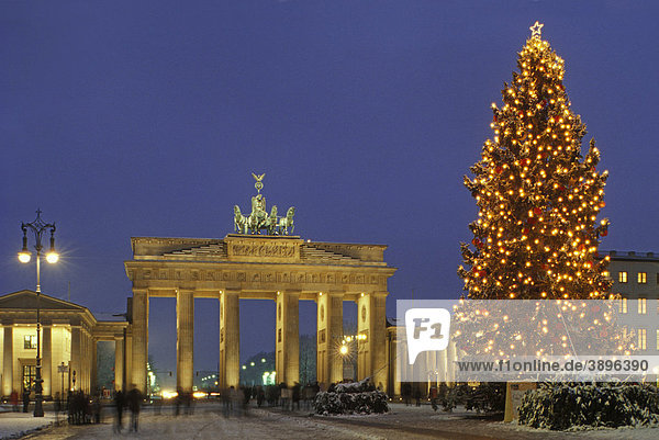 Brandenburg Gate in Advent season with snow and Christmas trees  Berlin  Germany  Europe
